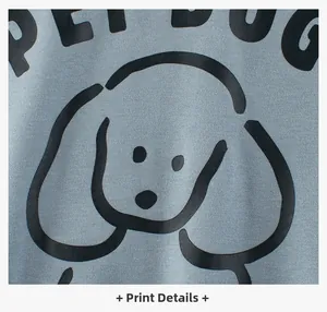 Detail of cartoon dog print and PET DOG text on light blue cotton sweatshirt fabric