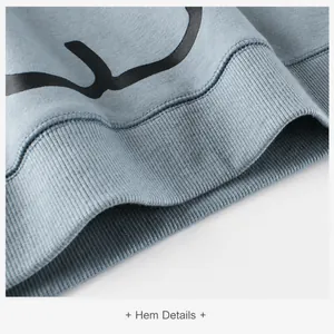 Close-up of ribbed hem details on a blue cotton knit sweatshirt with clean stitching