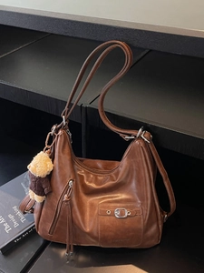 Brown vintage large capacity shoulder bag with multi-pocket design and teddy bear charm