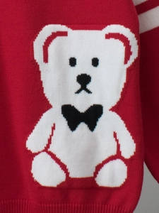 Red children knit sweater featuring cute white bear with bow tie and ribbed cuffs
