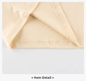 Detailed macro view of the double-stitched hem and clean inner overlock on cream cotton shirt