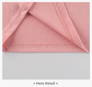 Close-up detail of the pink cotton knit t-shirt hem with clean double-needle stitching
