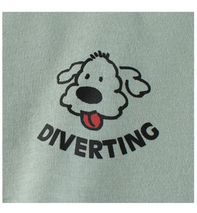 Close-up of cute cartoon dog print and DIVERTING text on light green cotton t-shirt