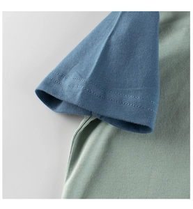 Detailed close-up of double-needle stitching on cotton raglan sleeves of kids t-shirt