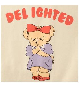 Close-up of Delighted bear cartoon print on beige cotton t-shirt fabric texture