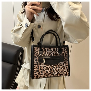 Chic leopard print faux leather tote bag with gold zipper detail and crossbody strap