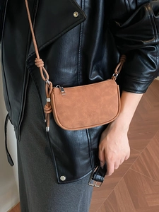 Minimalist brown crossbody bag for women with matte texture and slim shoulder strap