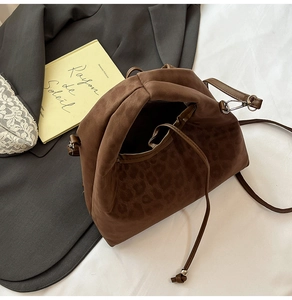 Detail of leopard print velvet cloud bag with drawstring closure and silver metal hooks