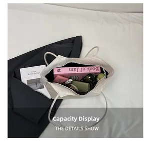 Spacious interior of white woven tote bag showing books and cosmetics storage