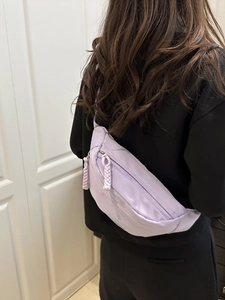 Light purple nylon crossbody fanny pack for women with braided zipper pulls shown on back