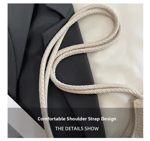 Detailed macro view of the woven cream faux leather shoulder strap for tote bag