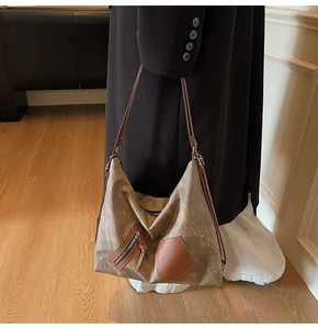 Close-up of a vintage brown large capacity tote bag with dual shoulder straps and textures