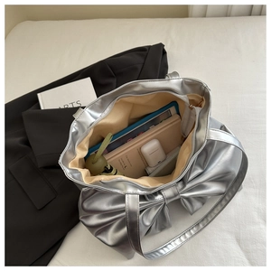Interior view of silver bow tote bag showing space for tablet, notebook and umbrella