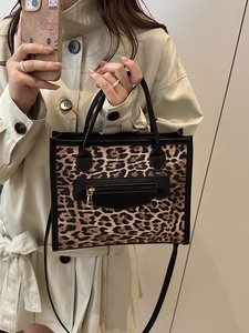 Fashionable leopard print tote bag with black trim and detachable shoulder strap
