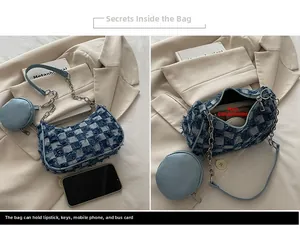Détail du sac baguette en jean à damier bleu avec chaîne argentée et petite pochette