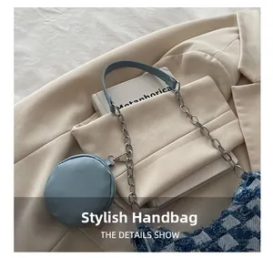 Detail of tweed crossbody bag featuring fringe edges and a round detachable coin purse