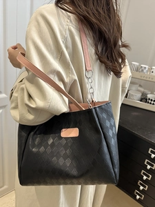 Quilted black nylon tote bag with pink leather straps and chain detail for women