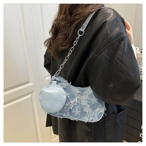 Blue denim underarm bag with frayed star patterns, metal chain strap and mini coin purse