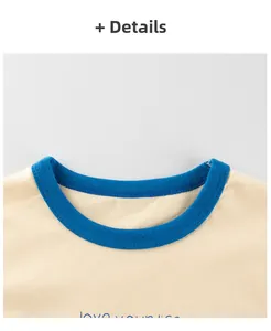 Detail of blue ribbed crew neck and neat stitching on beige cotton girls' t-shirt