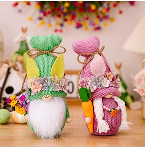 Detail of handmade knitted Easter gnomes with bunny ears and floral wreath accents