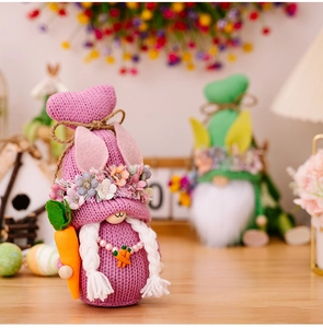 Macro shot of knitted Easter gnome featuring purple yarn, bunny ears and a felt carrot