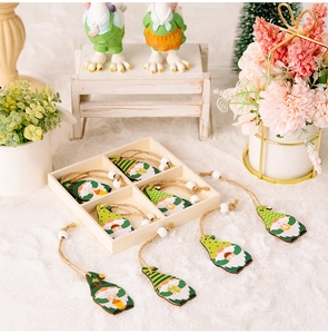 Detailed view of Saint Patrick's Day wooden gnome ornaments set in a rustic tray