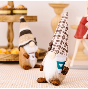 Detail of coffee gnome plush dolls with checkered hats and blue cups in cozy display