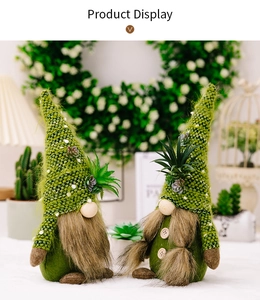 Detailed view of two succulent-themed gnomes with knitted hats and faux plant accents