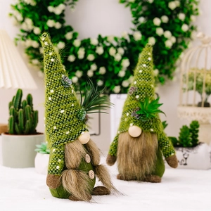 Handcrafted gnome plush with succulent hat and soft beard in a cozy indoor setting
