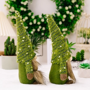 Detail of knitted gnome figurines with succulent accents and soft green textures