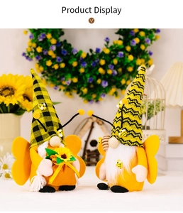 Close-up of handmade bee gnome plush toys with sunflowers and wooden honey dippers