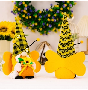 Detailed view of bee gnomes with checkered hats, wings, and sunflower decor in warm home setting