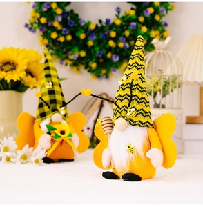 Macro detail of bee gnome plush with striped hat, wings and sunflower accessory