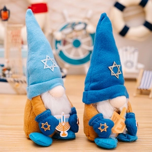 Detail of Hanukkah gnomes with blue sequins, Menorah and Dreidel on a wood surface