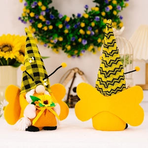 Pair of bee gnomes with striped hats and wings for home decor on sunflower background