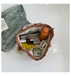 Inside view of corduroy tote bag showing spacious capacity with everyday essentials