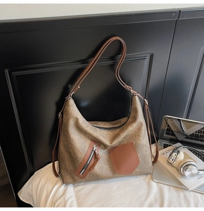 Detailed close-up of a large capacity tote bag with distressed texture and front pockets