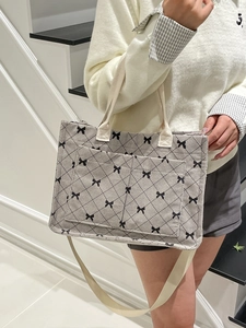 Grey corduroy tote bag with black diamond bow patterns and adjustable shoulder strap