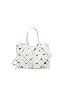 Cream quilted tote bag with black bow patterns and dimensions shown on white background