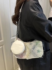 Y2K style canvas handbag with star pattern and metal chain shown on model shoulder