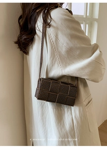 Detail of retro brown woven texture shoulder bag with minimalist flap design