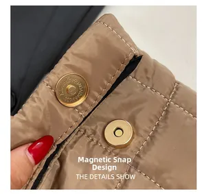 Detailed macro view of gold magnetic snap closure on brown quilted fabric material