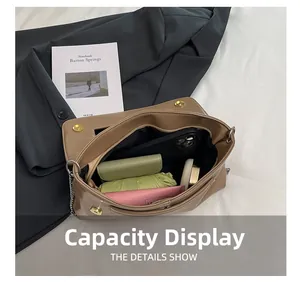 Detailed interior capacity showing large storage for phone, wallet and umbrella in beige bag