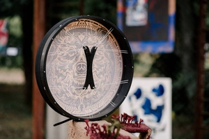 Detailed back view of Siberian Shamanic drum showing ropes and black wooden X-grip handle
