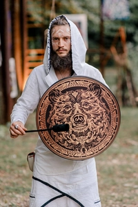 Close-up of Shamanic frame drum featuring a detailed brown bear totem and wooden drumstick
