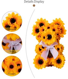 Detail display of sunflower bear ornament featuring artificial petals and a white ribbon bow