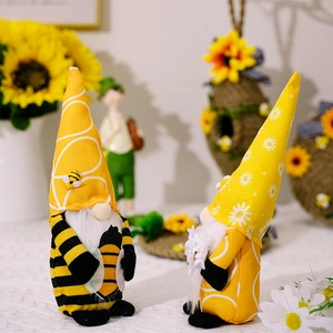Detailed close-up of handmade bee gnomes with sunflower and stripe patterns