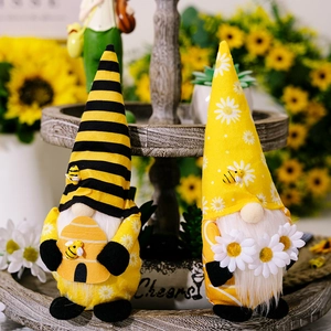 Detailed plush bee gnomes on wooden tiered tray with sunflowers and rustic spring decor