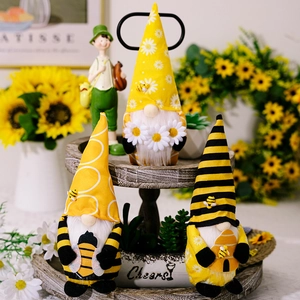 Three bee gnomes with sunflower hats on a tiered tray for festive home decor