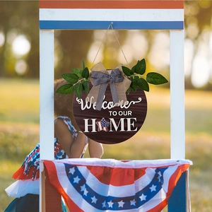 Detail of rustic wooden welcome sign with burlap bow and patriotic star design